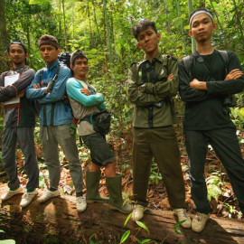 Members of a SMART patrol team pose for the camera on a forest patrol of the environment they protect. 