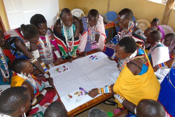 Participants at a FLoD learning event in Kenya sit around a table