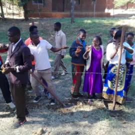 Training community members from Kasungu on construction skills.