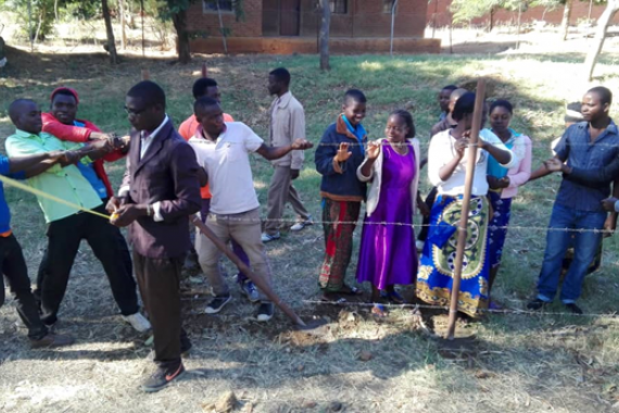 Training community members from Kasungu on construction skills.